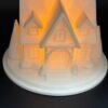 img 9500 Front view of the Snowy House light up Christmas house – white 3D printed house with dormer windows, arched porch, chimney and trees, glowing with warm LED light