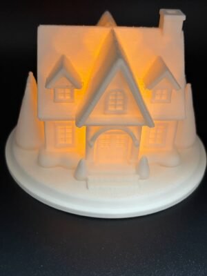 img 9500 Front view of the Snowy House light up Christmas house – white 3D printed house with dormer windows, arched porch, chimney and trees, glowing with warm LED light